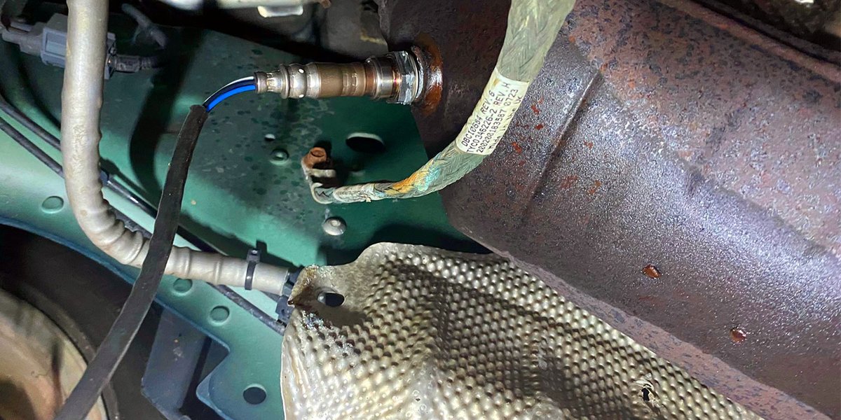 Close-up view of an oxygen sensor and its wiring harness