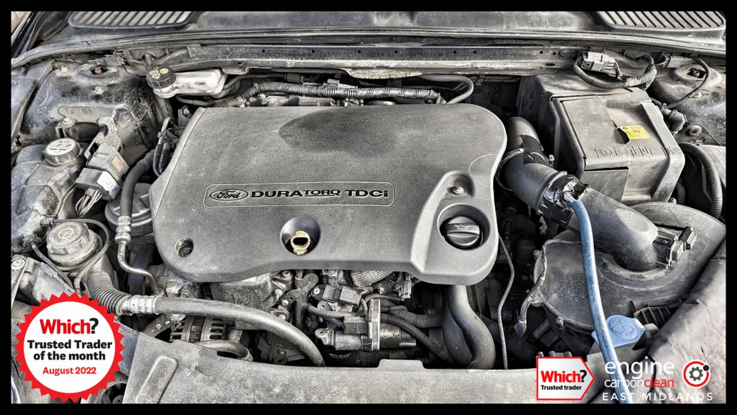 Mechanic performing a smoke test on an engine to find boost leaks