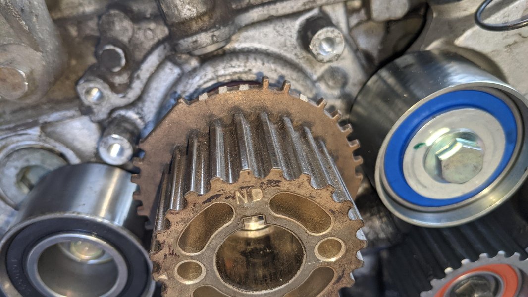 A visible example of damage to a tone ring, which can severely impact crankshaft position sensor readings.