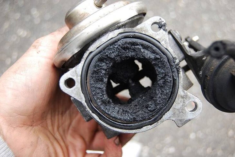 Severe carbon buildup in an engine component, illustrating the problem that causes P0401.