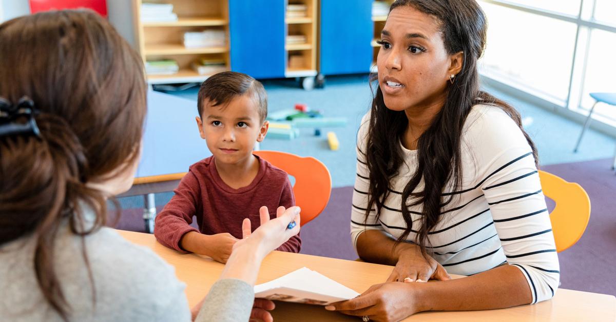 school building with engaged parents