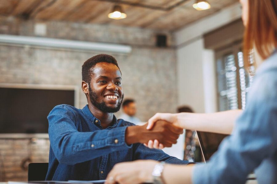 Two professionals shaking hands, symbolizing agreement or successful interaction