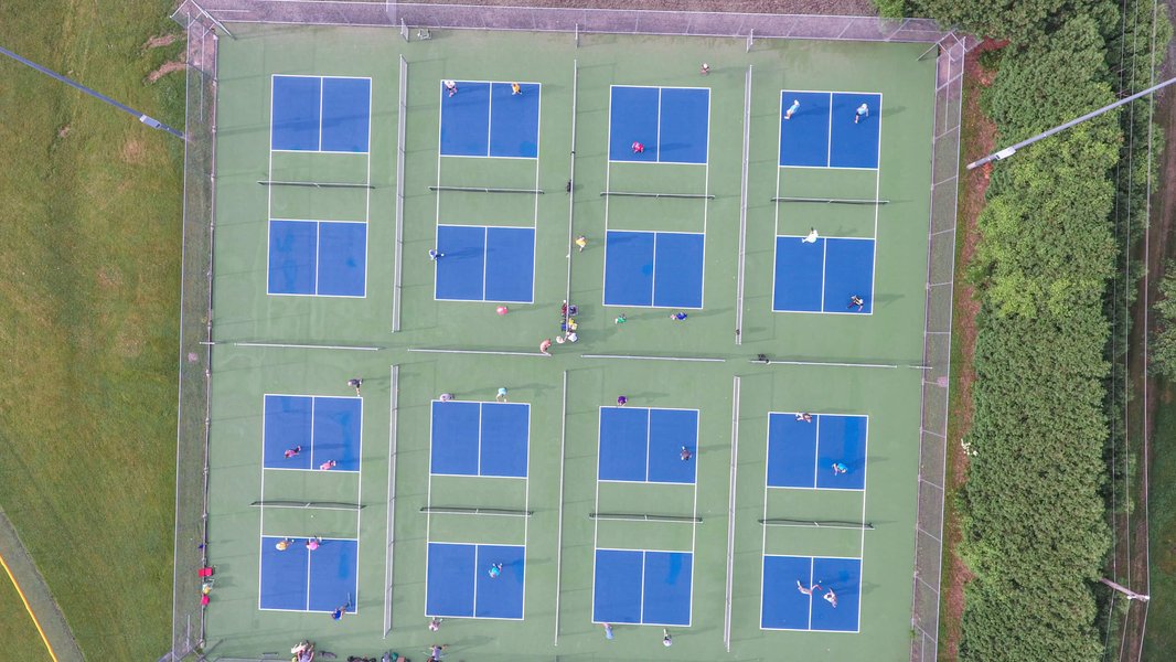 Overhead view of pickleball players positioned on the court