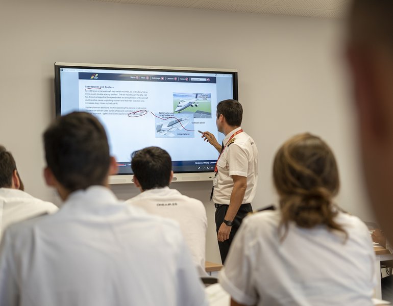 Students in a flight school classroom setting