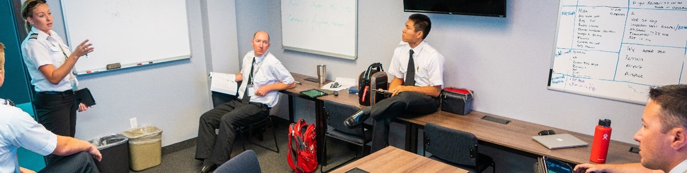 Flight instructor teaching students in a classroom