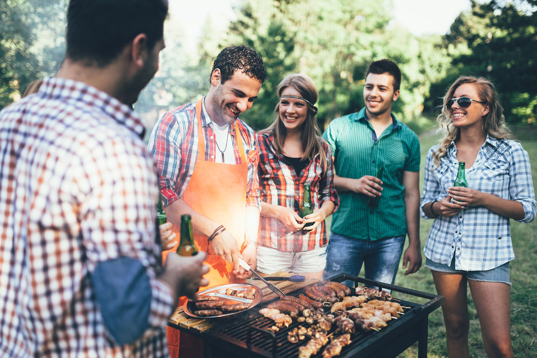 group of friends cooking outdoors