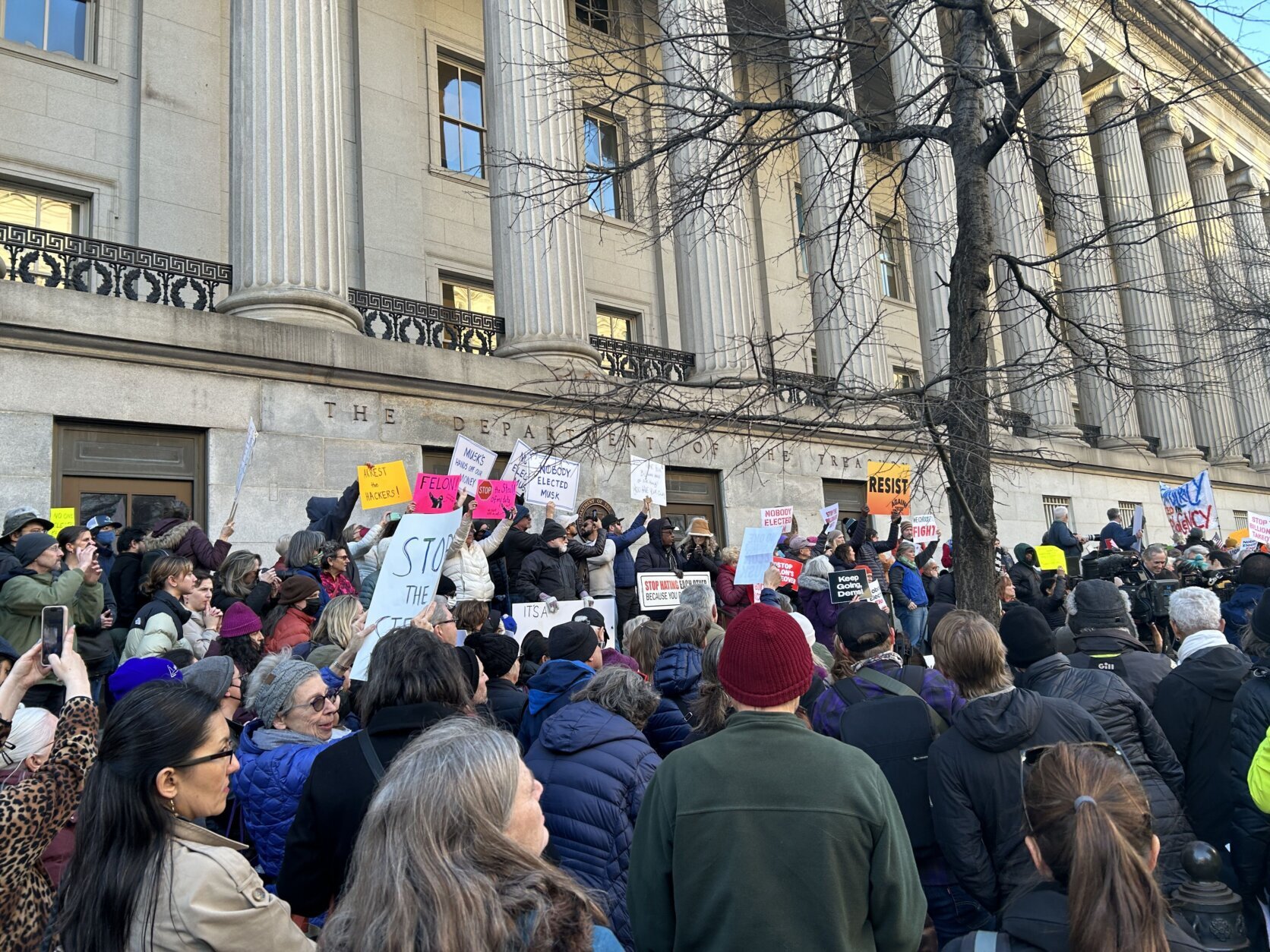 government building and protest crowd