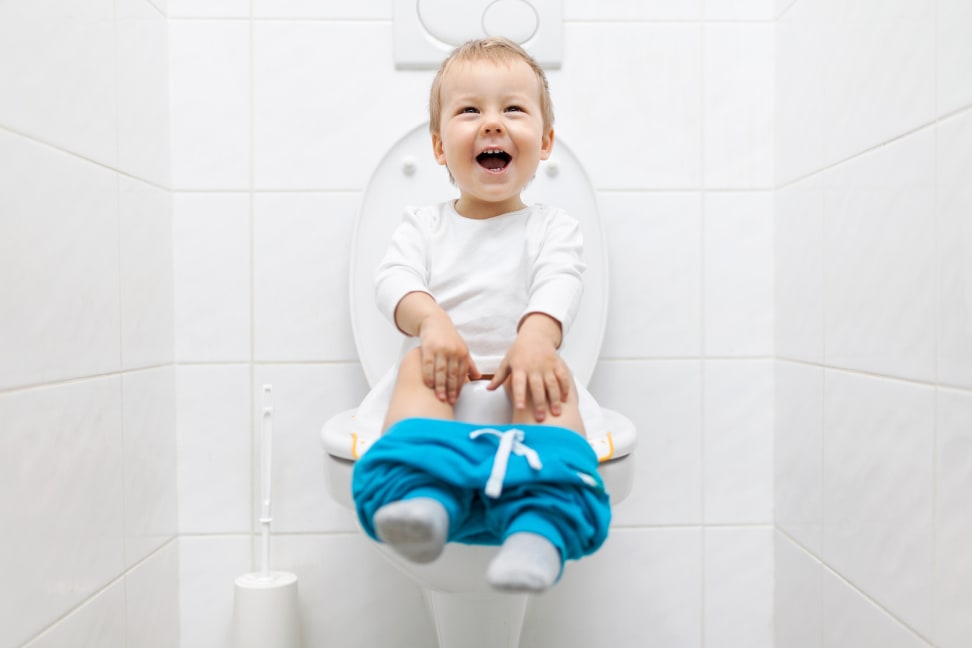 child using a potty chair in a bright, friendly bathroom