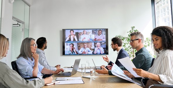 organizational meeting, diverse professionals in discussion, technology workspace