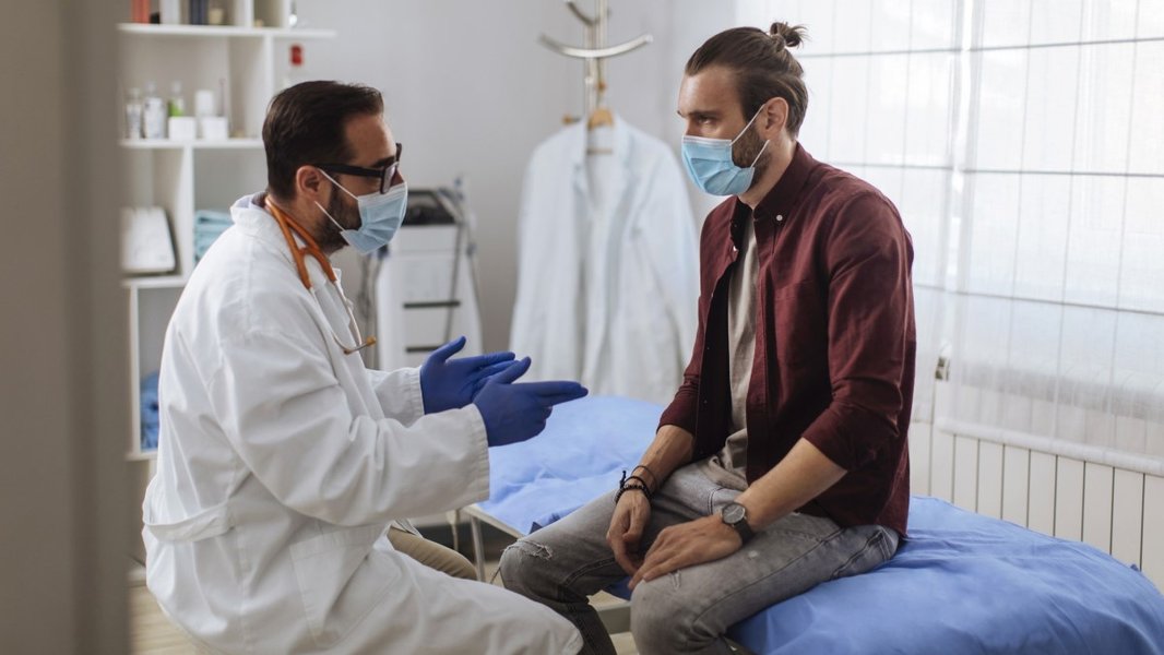 A doctor discussing screening options with a male patient.