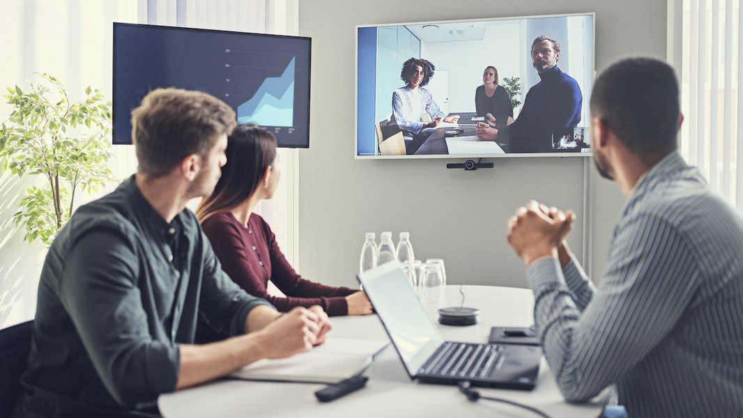 Person working remotely on a laptop in a comfortable setting