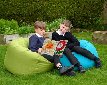 children reading outdoors