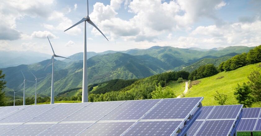solar panels and wind turbines in landscape