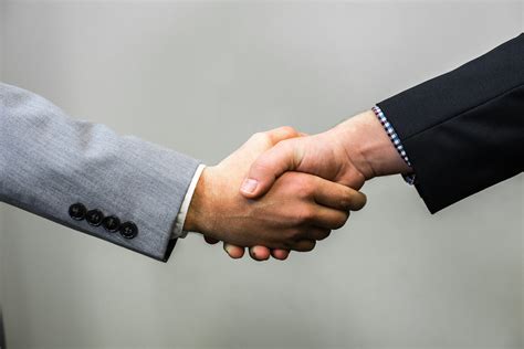 person greeting with handshake