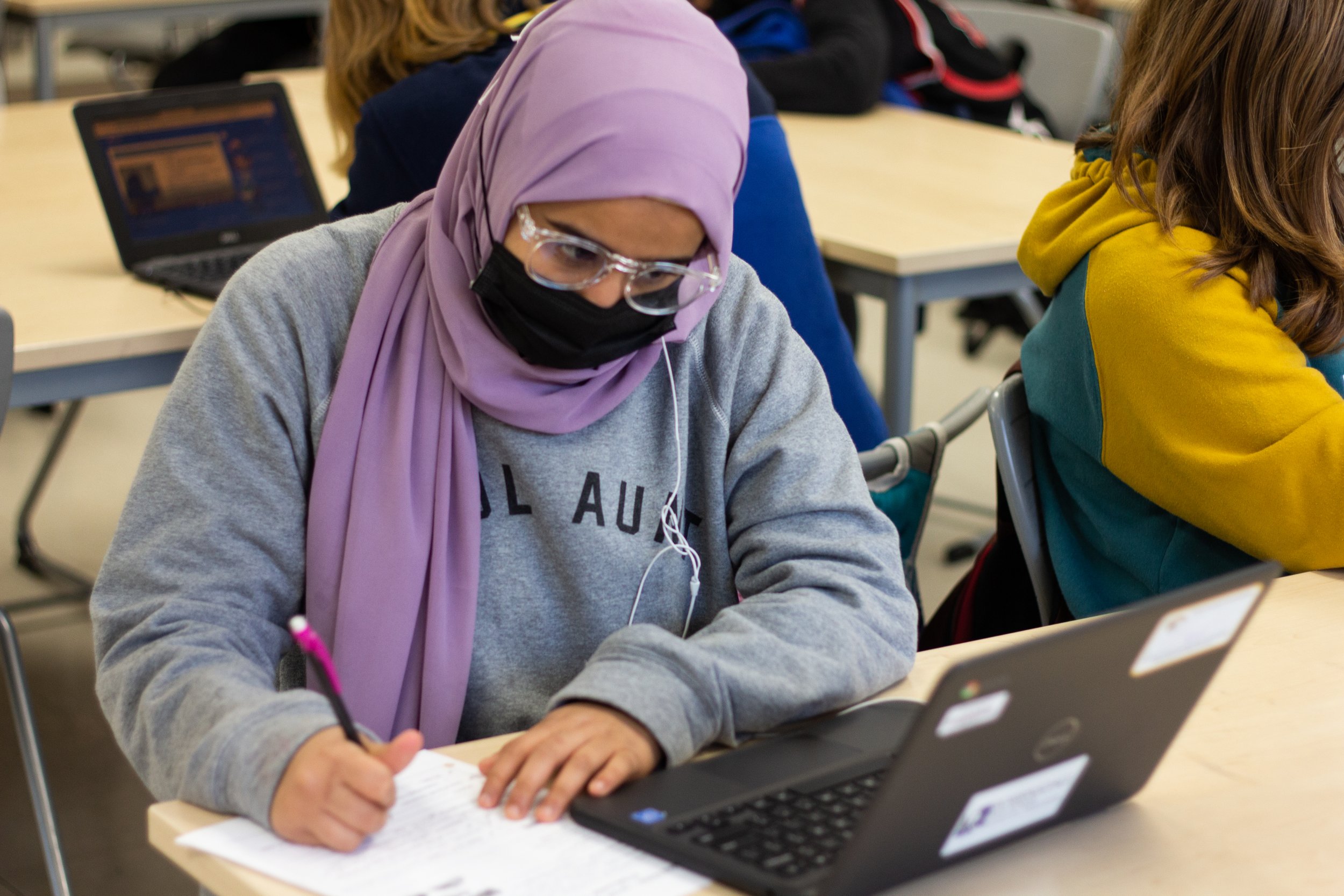 students taking notes in a modern classroom