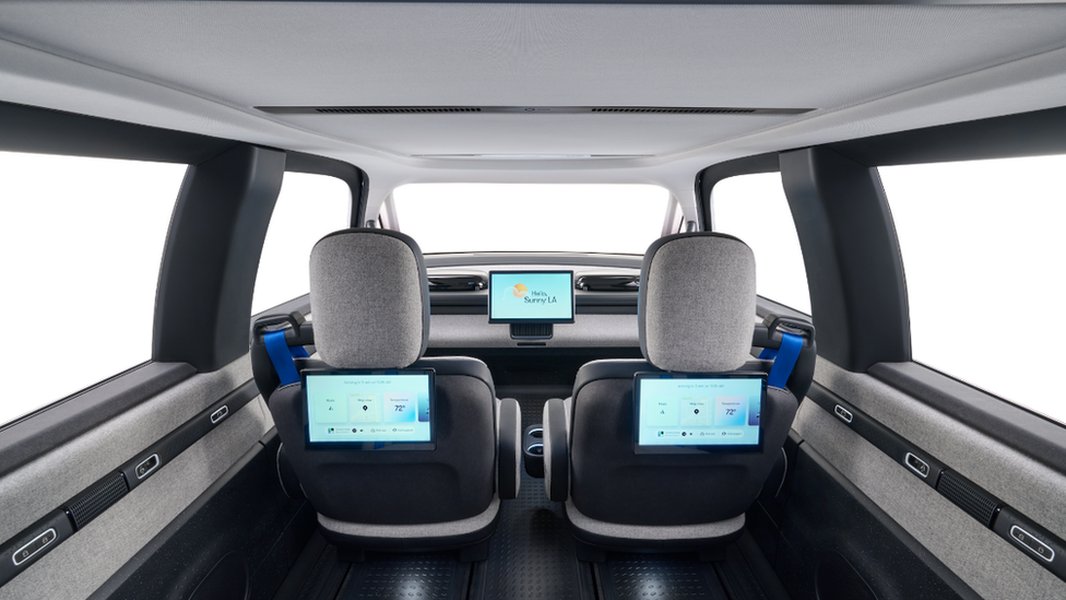 The interior of a Waymo robotaxi, showing the passenger-centric design and interface.