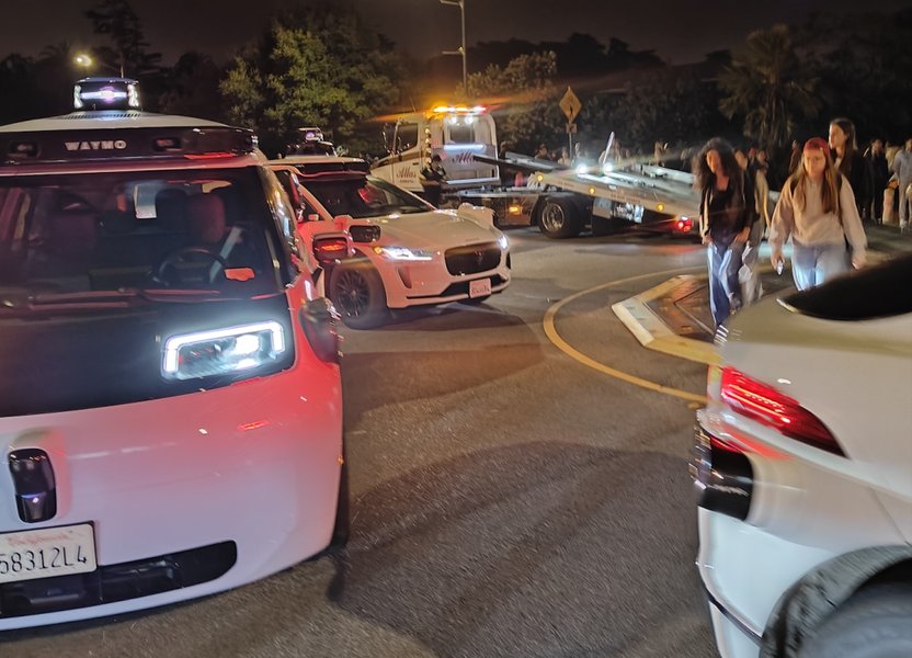 A Waymo robotaxi navigating city streets, showcasing the integration of advanced sensors.