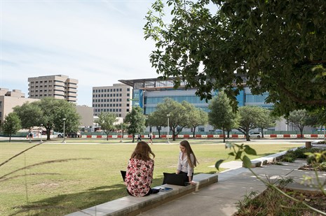 landscape with academic buildings and technological devices