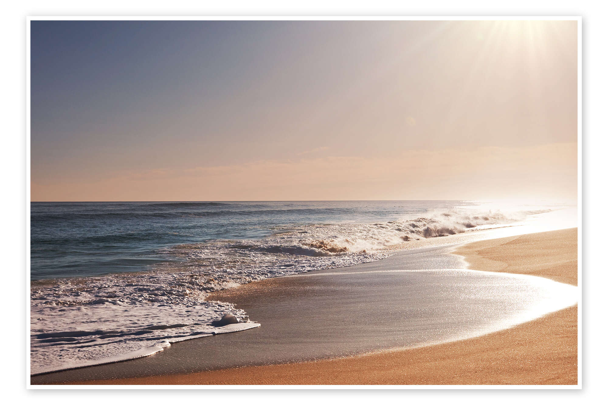 sunlit beach sand water