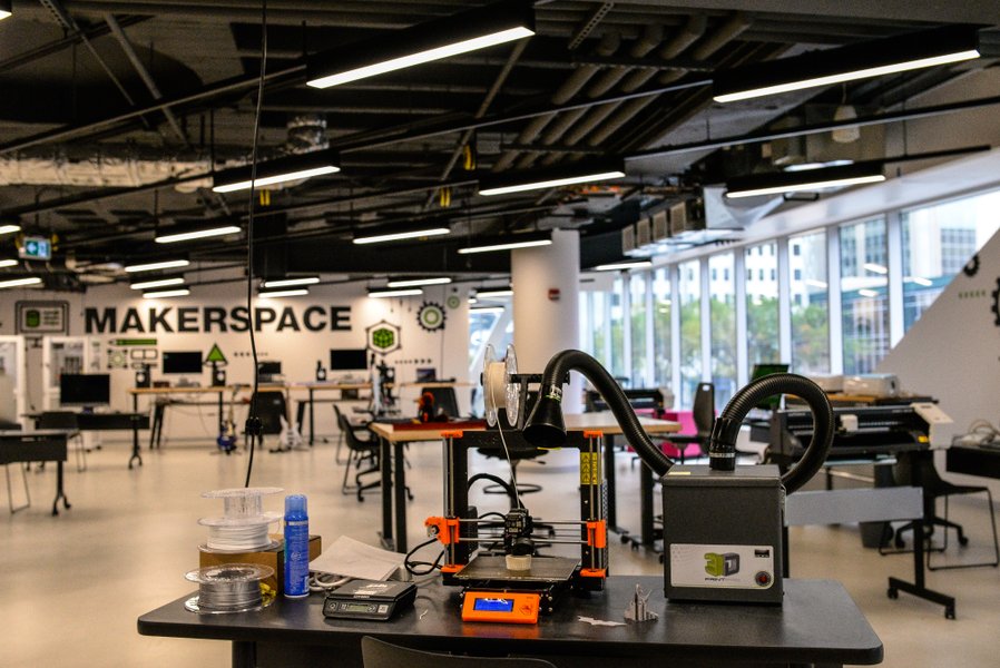 A well-equipped library makerspace with various tools and workstations