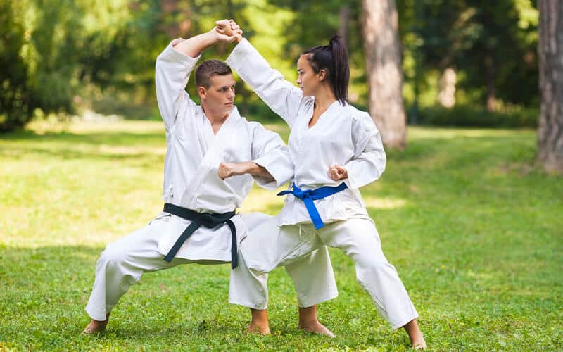 women training martial arts outdoors