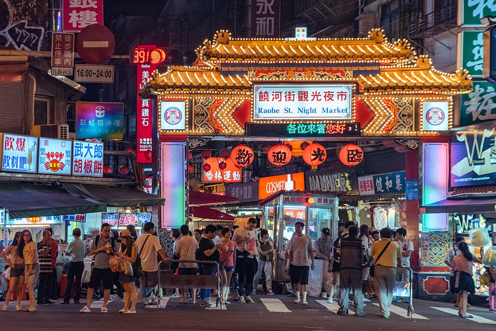 Taiwan city nightscape, bustling street market, modern workspace