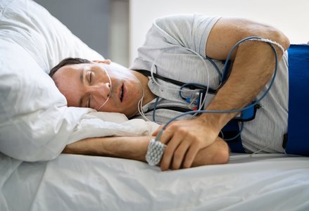 sleeping patient, diagnostic sleep equipment, nighttime cityscape