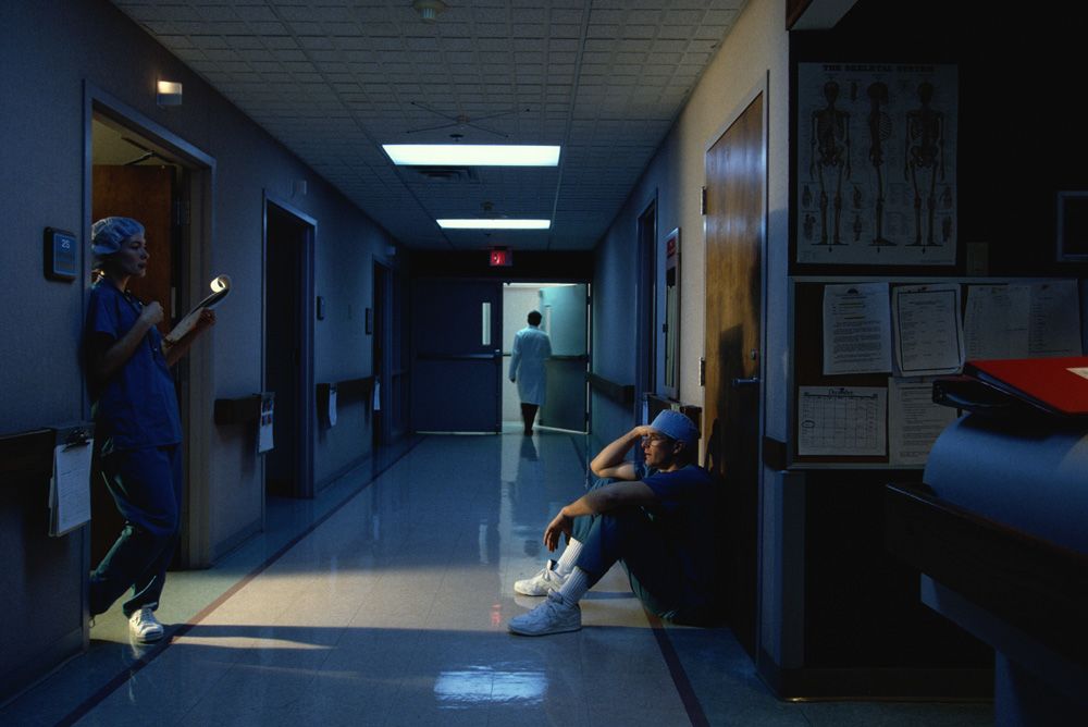 nurse working late shift in hospital corridor