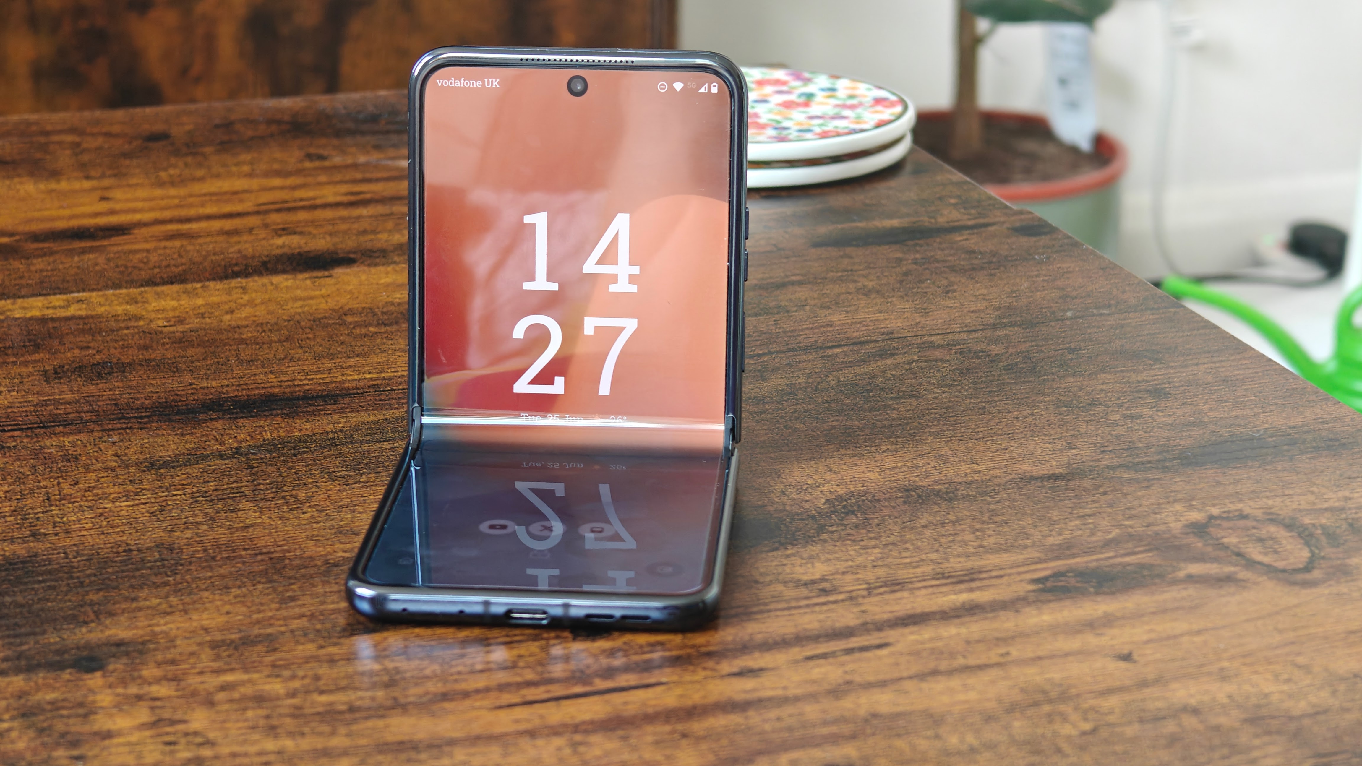 smartphone display, modern phones on table, sleek tech devices