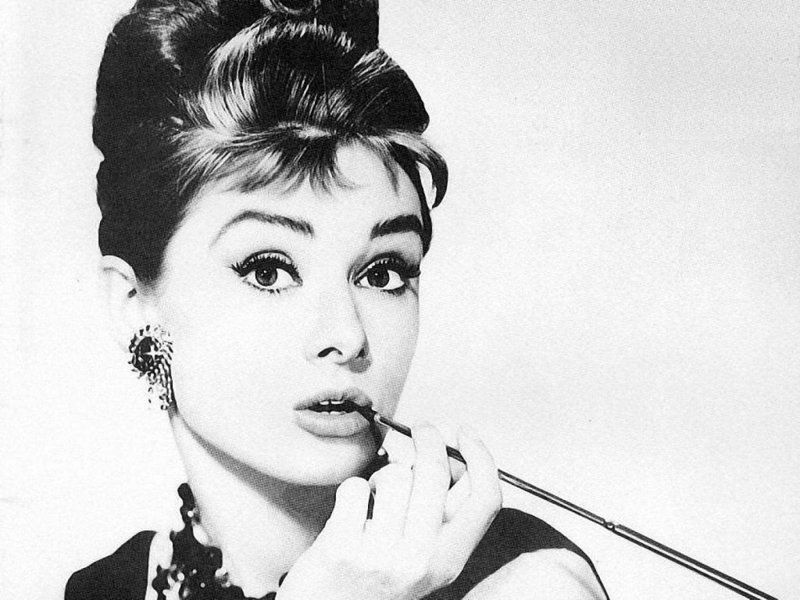 Audrey Hepburn smoking a cigarette with a holder