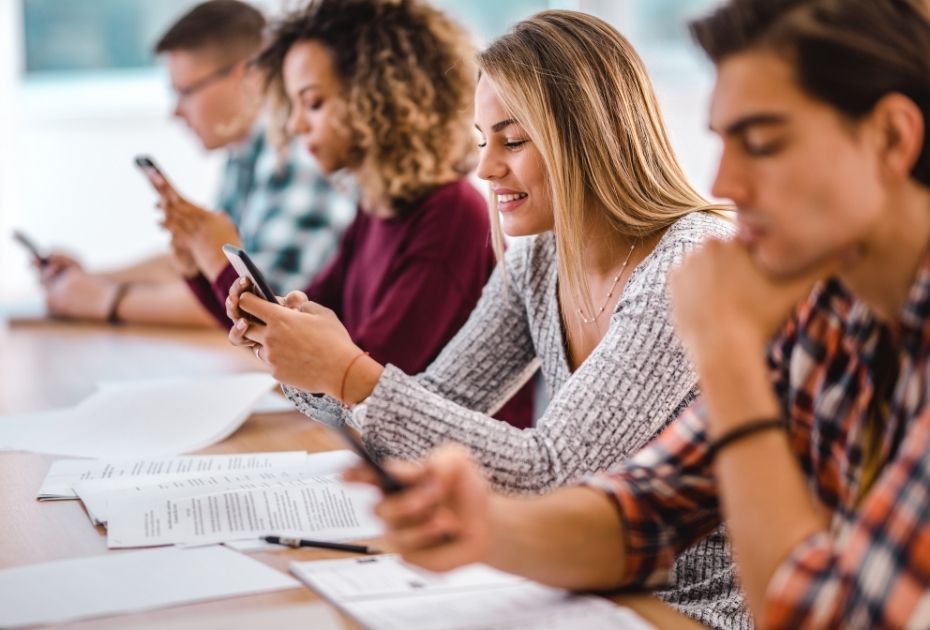 students using mobile devices in study group