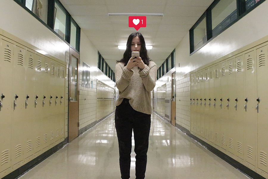 students in school hallway social media use