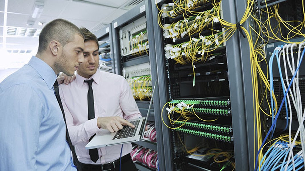 A server room with multiple racks of blinking servers and network cables, illustrating the backbone of digital operations including blockchain.