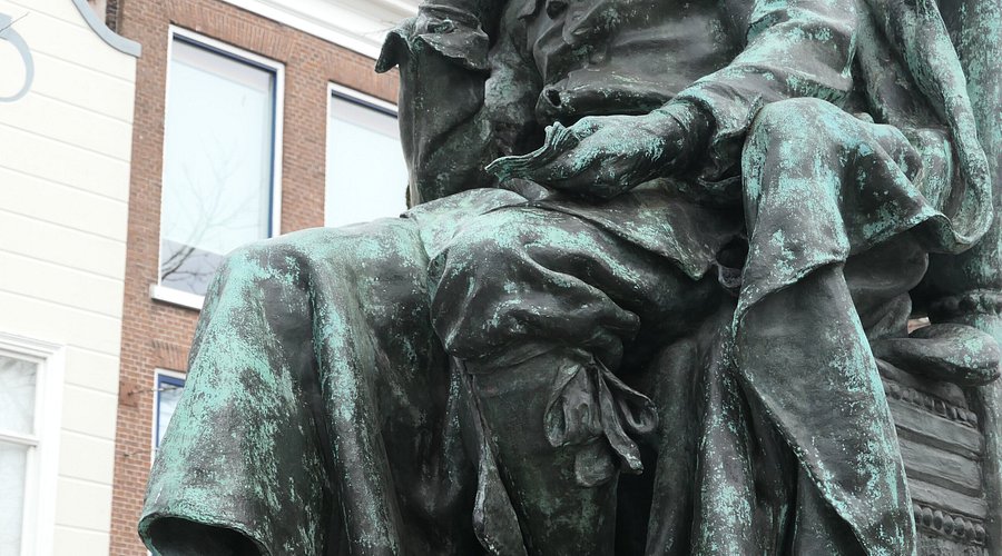 sculpture of spinoza books library