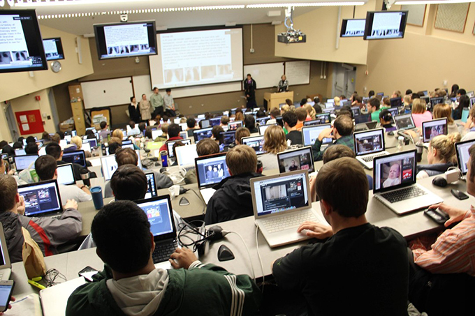 students using digital devices in campus setting