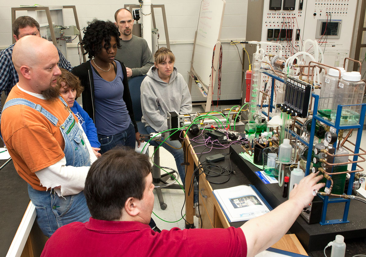 students in training workshop with technology equipment