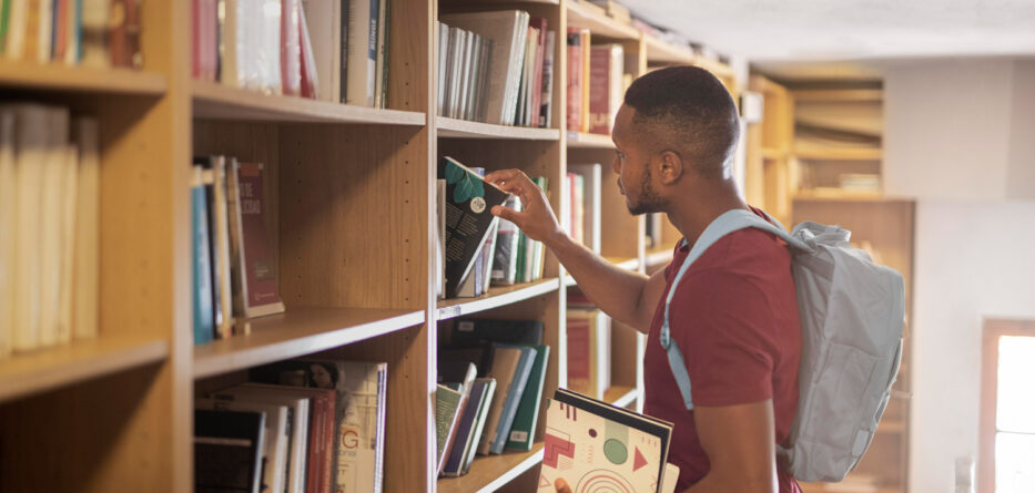 student studying in library with books