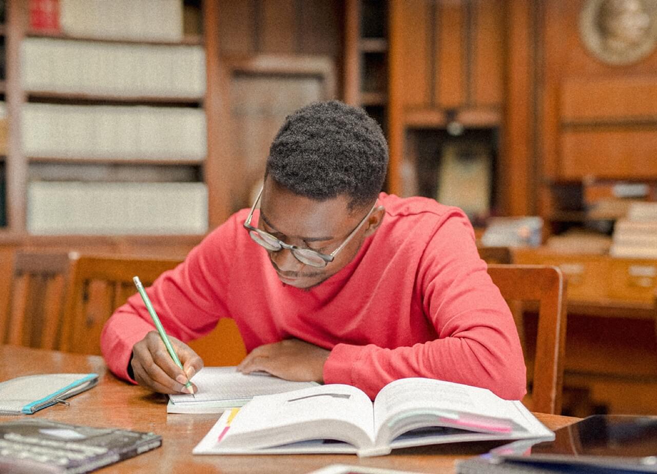 focused student studying with books and notes