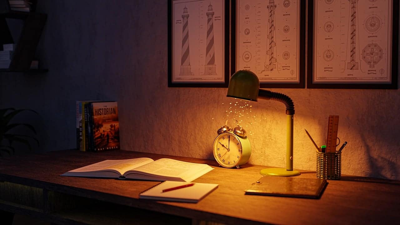 study desk with books and desk lamp
