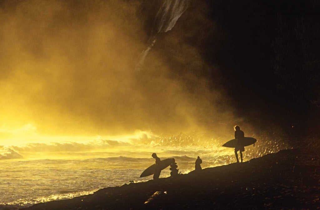 surfing waves on volcanic beach