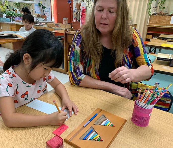 Children using Montessori beads for addition