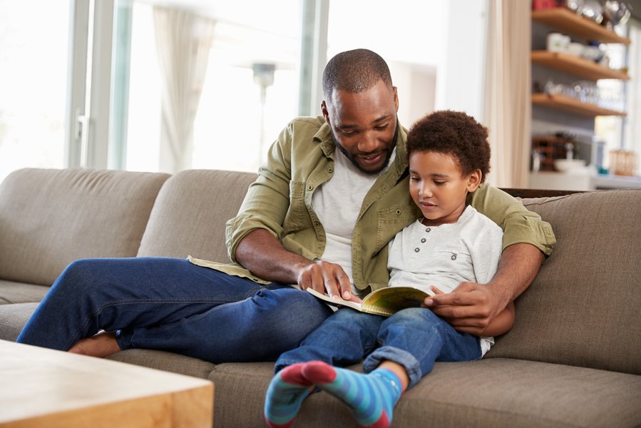 Parent and child looking at a picture book together