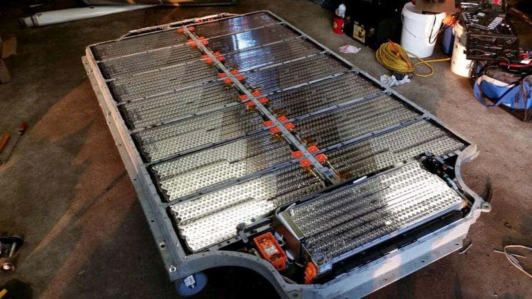 A Tesla Model 3 battery pack being prepared for removal.