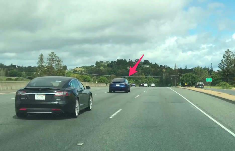 A Tesla Model 3 undergoing highway testing, where real-world range can differ significantly from EPA estimates.
