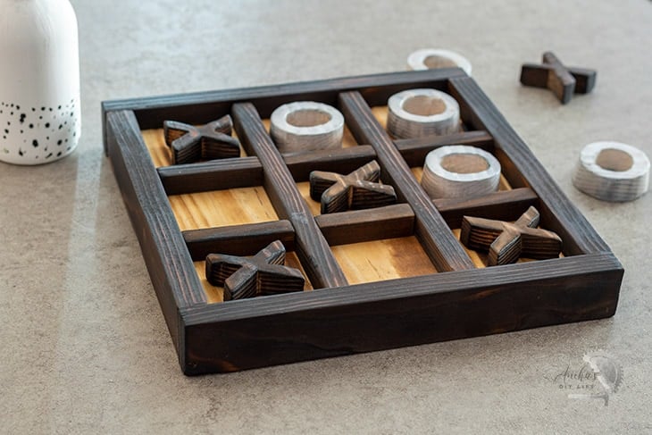 tic tac toe game board on wooden table