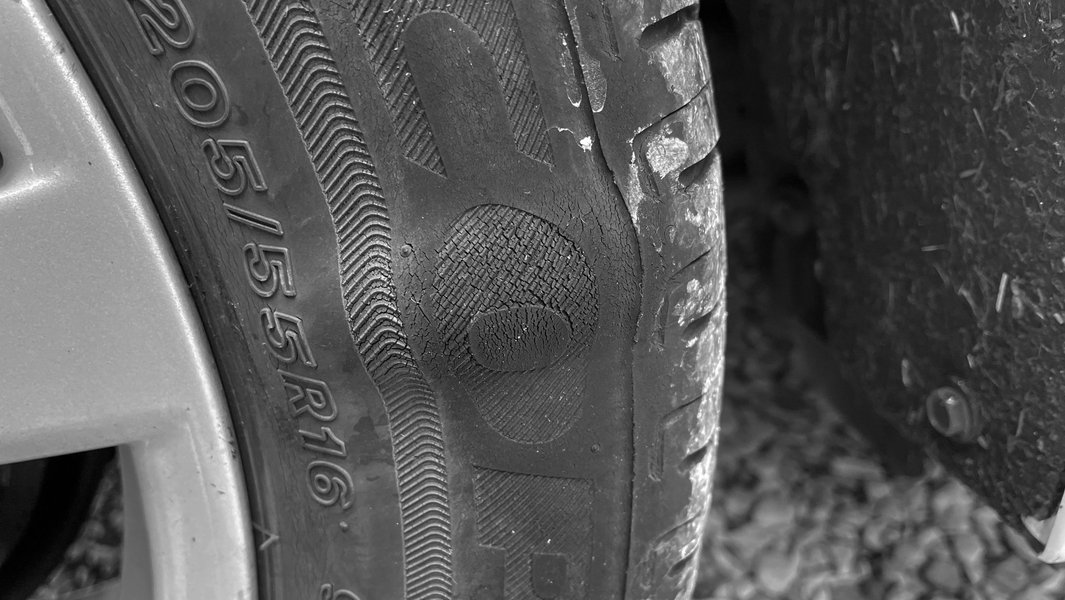 A tire with a dangerous bulge on its sidewall