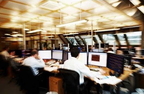 financial trading desk, charts, physical office environment