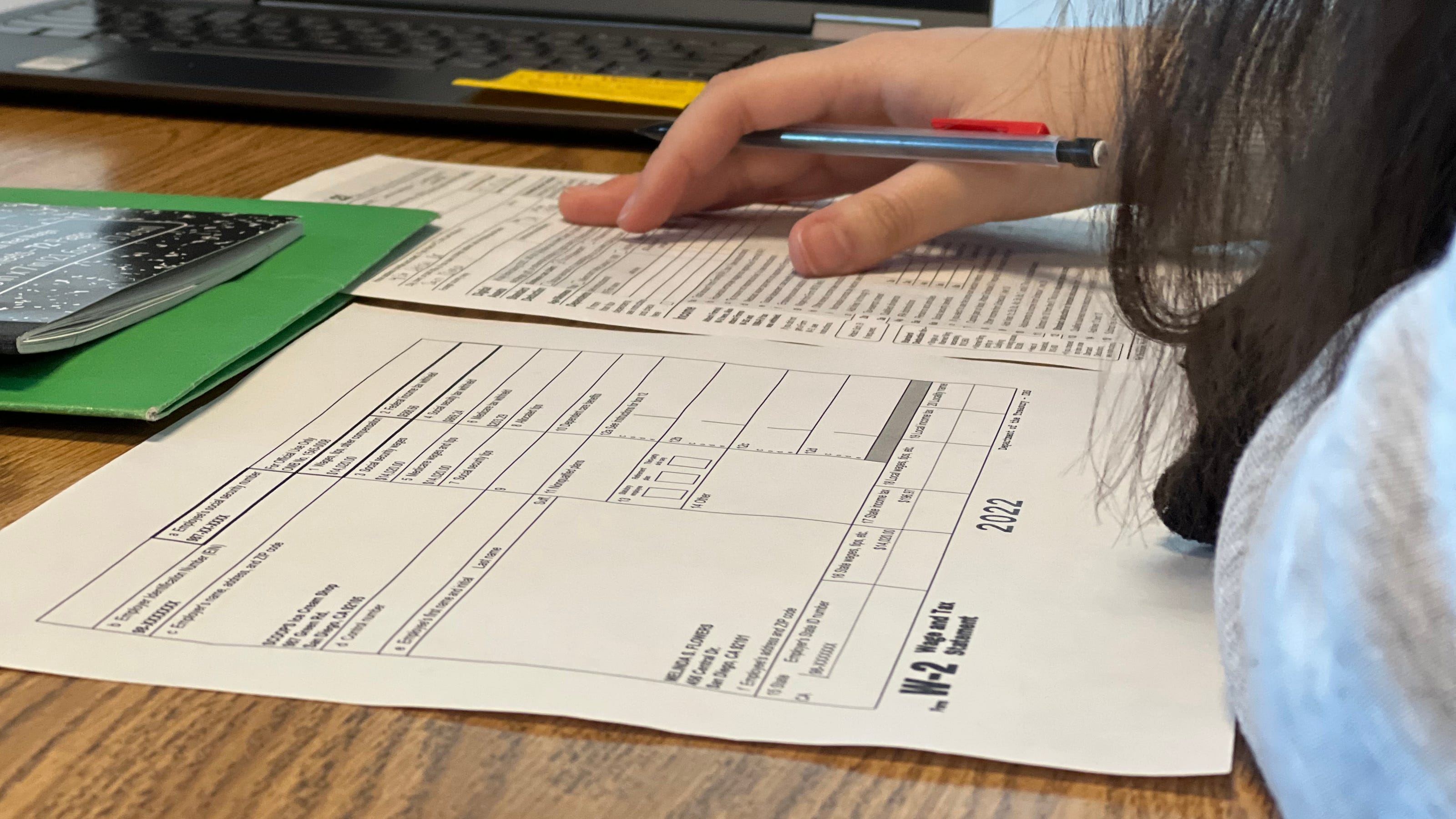 physical documents and tax forms on a desk
