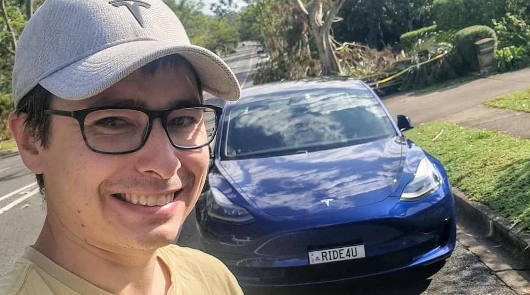 An electric vehicle, like the Tesla Model 3, being used for ridesharing, highlights the growing need for specialized insurance.