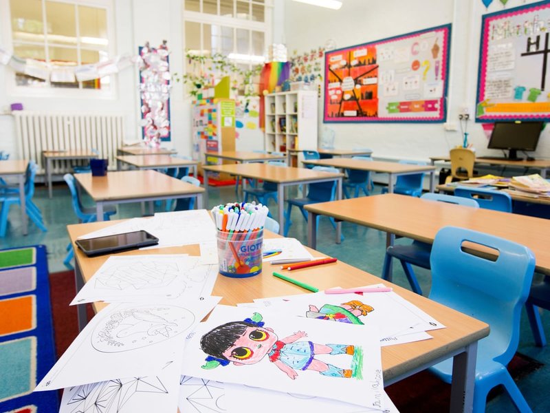 Primary school classroom with children working at desks